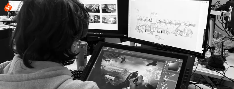 An artist painting concept art on a pen display