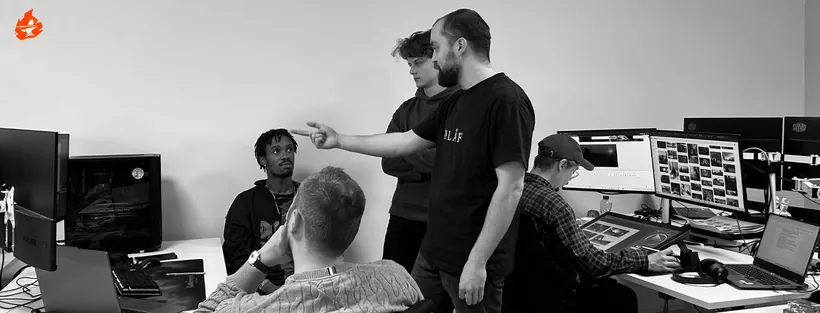 Team members discussing work at their desks