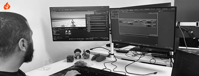 A developer working on gameplay logic across two monitors